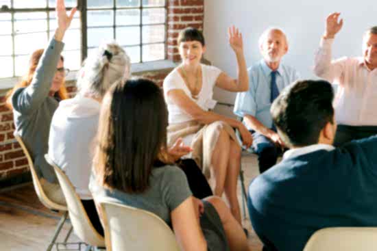 People raising hands to ask